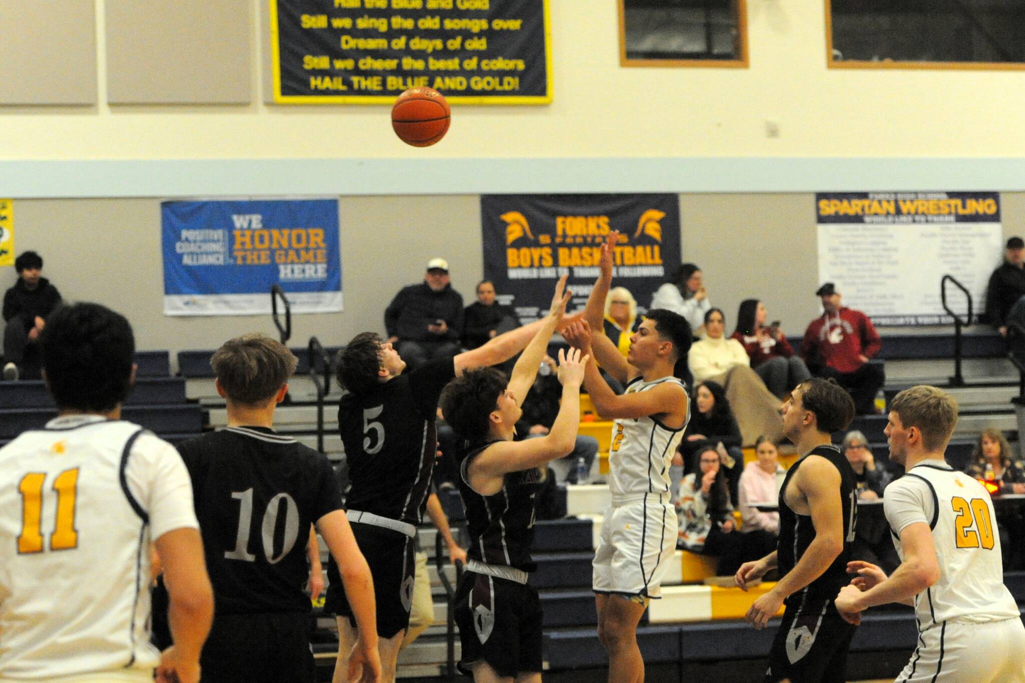 Noah Foster put up this shot against Raymond-South Bend during this league contest won by Forks. Also in the action are Spartans Cash Barajas and Ty Rowley.