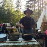 Above, Larry Baysinger sets                                 out the Dutch oven meal at the Littleton​ Horse Camp.                                 Photo Zorina Barker