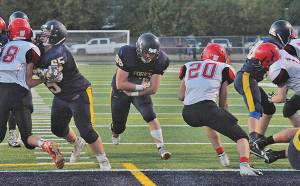 Spartan Running back Caleb Peters finds a hole behind the blocking of Corbin Baker (65) and Shane Queen (68) during homecoming as Forks defeated Neah Bay 50 to 0. Next up is Montesano at Forks. Photo by Lonnie Archibald