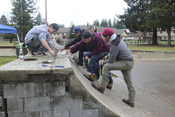 After meeting with City of Forks Public Works Director Paul Hampton Friday morning, this group went to work repairing the vandalized mini-ramp at the skatepark at Tillicum Park. The city donated money which was used to buy a 5-gallon bucket, one bag of concrete and an adhesive which was applied with a caulk gun. The other tools such as trowels, buckets, brooms, air hammer and air compressor were donated by Justin Sane Carner and Josh Gray. Photo Christi Baron