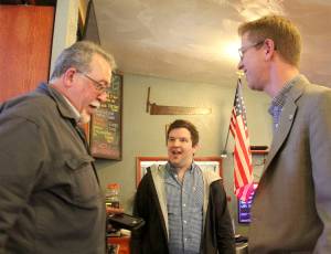 Congressman Derek Kilmer, right, speaks with Quileute Oceanside Resort manager Larry Donnelly, left, as Kilmers Communications Director, Tim Biba, looks on after the Forks Chamber of Commerce meeting adjourned last Wednesday afternoon in Forks. Photo Christi Baron