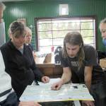 Justin Carner points out several possible biking trails, on a map, in the Forks area and some closer to Port Angeles. Photo Christi Baron