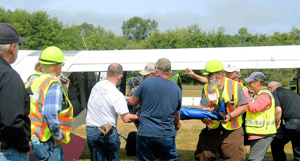 It was a tight fit to get this injured individual with a broken leg in this plane, but volunteers got it done, and then spent some time discussing how it went.