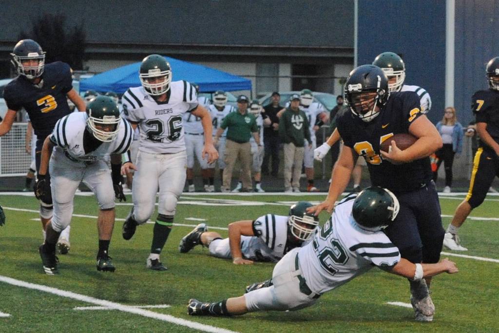 Tristen Pisani (34) had a good game against the Roughriders. Forks defeated Port Angeles 28 to 8. Also in on the action is Spartan Brett Moody (3). Photos by Lonnie Archibald