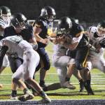 Spartan Caleb Peters (99) crosses the goal line for another Spartan touchdown while Luke Dahlgren and Eden Cisneros block.