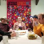 The group enjoys a meal and warms up at the Prince of Peace Church in Forks, PPLC, Church members Rod Fleck and his children Emma Grayce and William, at the head of the table, served as hosts. Submitted Photo