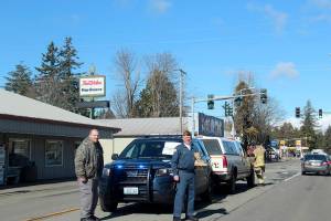 Forks Police Chief Micheal Rowley and VFW member Mike McCracken, seen here, and Forks volunteer firemen Izaak Manuel and Reece Depew filled several boots with donations during a fundraiser Sunday for the Gold Star Families Memorial Monument. Photo Christi Baron