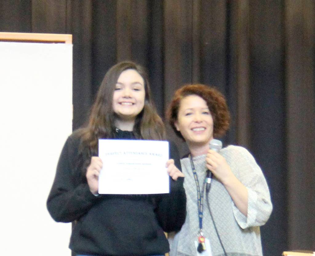 Hailey Ekegren had perfect attendance for the first semester, seen here with Sarah Decker who filled in as master of ceremonies.