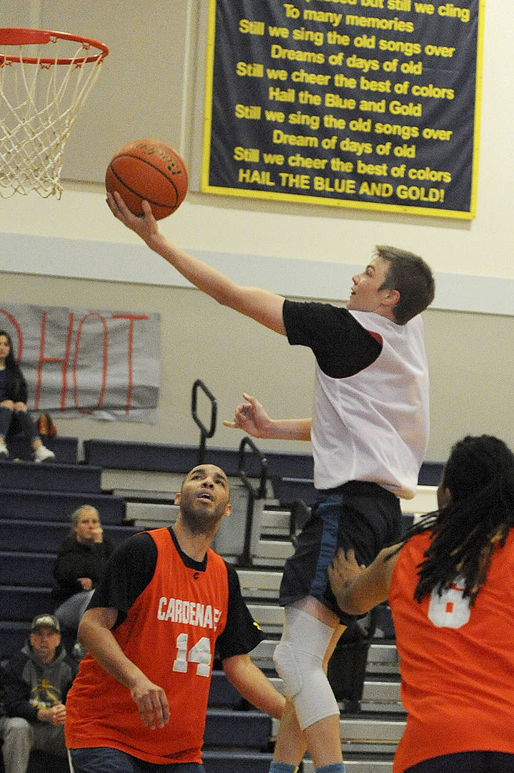 Forks Joseph Reaume playing for Dilley and Soloman puts up a shot against the Cardinals of Seattle during the Nate Crippen Memorial Tournament played in Forks over the weekend. Tied with only three minutes left, some three-point shots by the Cardinals in the closing minutes gave the Seattle team a 58-48 win. Photo by Lonnie Archibald