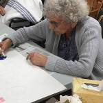 Pauline Adams coloring thank you signs for the 4th of July parade.
