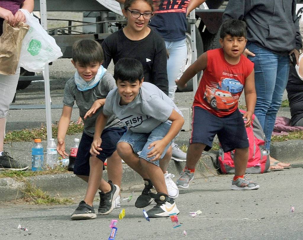 There was lots of candy along the parade route for kids as is evident here as children rush to the goodies.