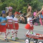 Salute! they are a walking US Flag! The American Girls, sponsored by the Parlor Café of Forks, walk the parade route with a wagon full of candy. Standing together the American Flag is revealed. Photos by Lonnie Archibald