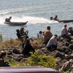 Visitors look on as rooster tails fly from outboard canoes during the annual races on the Quillayute River during Quileute Days in La Push Saturday.