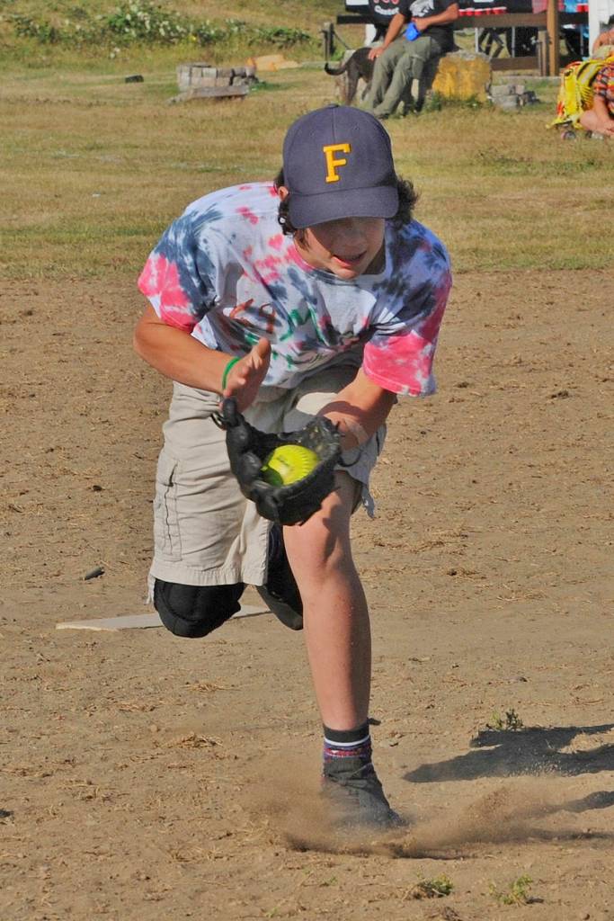 Forks Misfits pitcher Walker Rondeau makes a running catch of a pop up against LaPush who Forks defeated during the Quileute days Youth Softball Tournament held in LaPush.