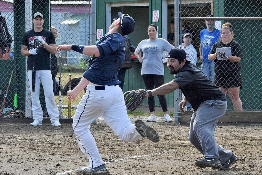 Parker Browning of the Forks Merchants was tagged out at home by Jerrys Nads pitcher Mike Astrada as Browning attempted to stretch a triple into a home run. The Merchants downed Jerrys Nads 16-3. Photos by Lonnie Archibald