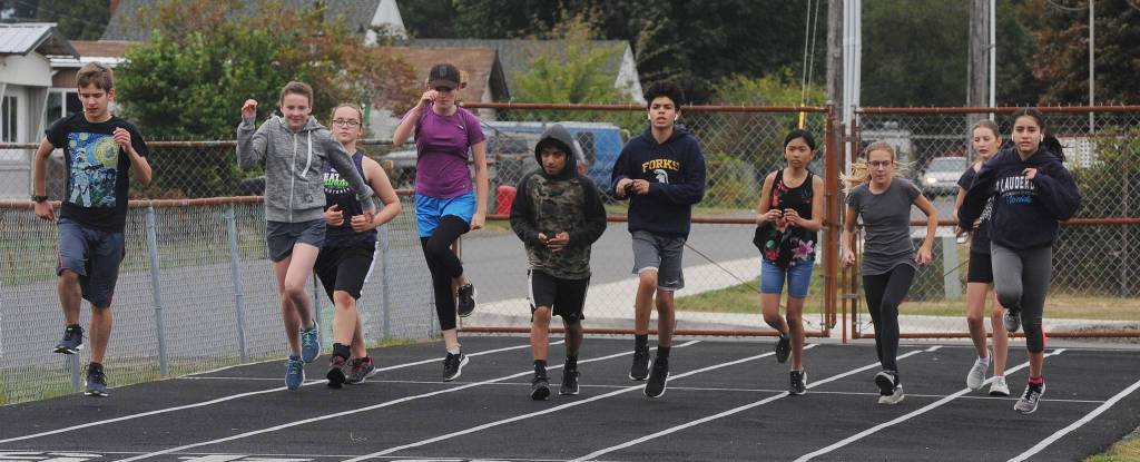 A portion of this seasons cross country team warms up at Spartan Stadium. Photo by Lonnie Archibald