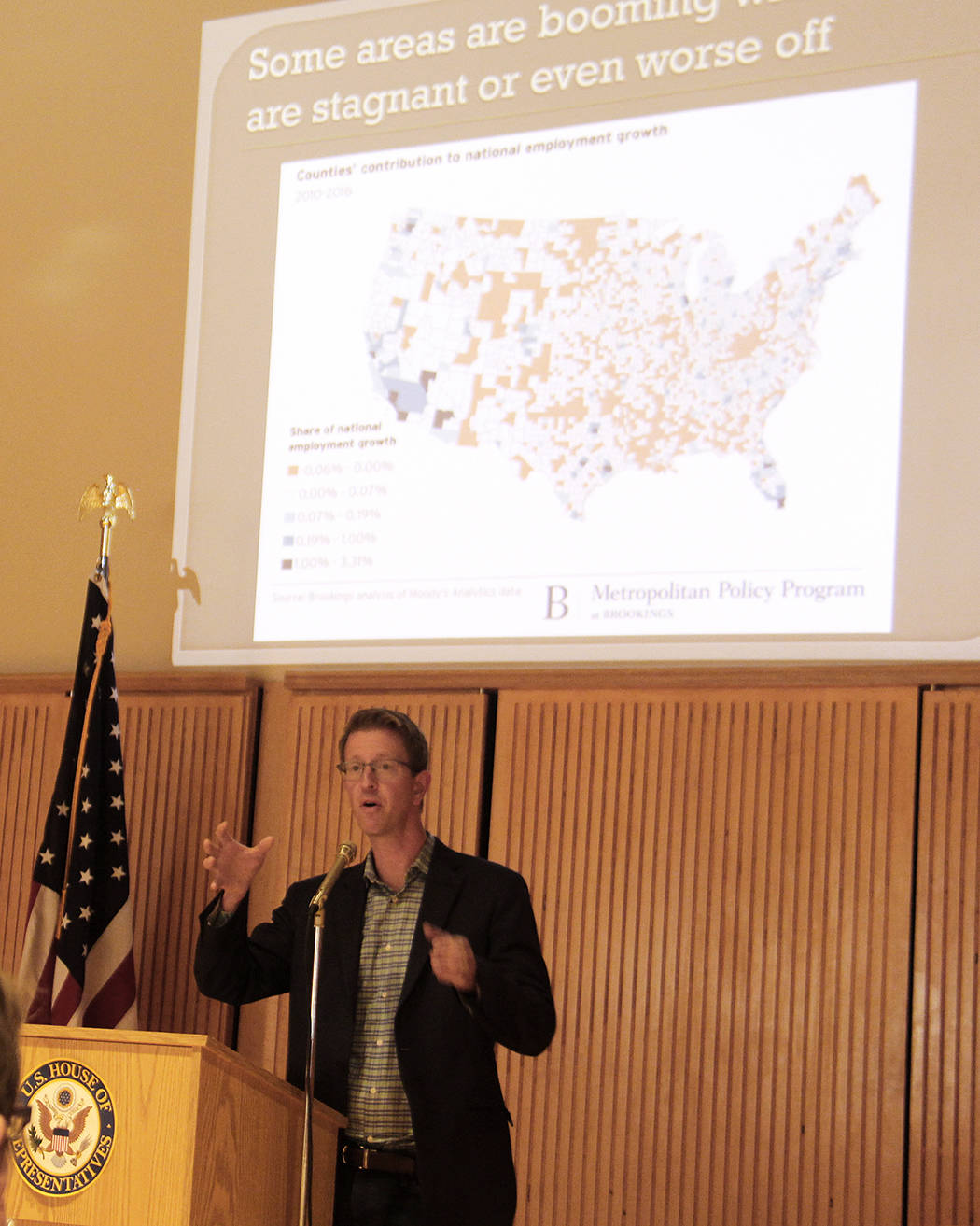Representative Derek Kilmer stands in front of a slide of a US map showing the areas in our country that are booming, stagnant and some that are worse off, as he spoke to a group of about 50 people at a Town Hall meeting at the Rainforest Arts Center last Wednesday evening. Photo Christi Baron