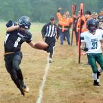 Clallam Bay senior quarterback Ryan Strid tiptoes to stay in bounds after breaking free from the Muckleshoot Tribal School defense for a second quarter touchdown on Friday during the Bruins 68-20 win. Photo by Mike Salsbury for the Forks Forum.
