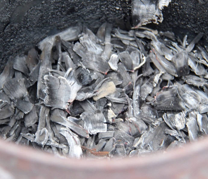 After the chips are burned at the correct temperature to the desired state they are removed from the burner and doused with water. If they burn down to ash they are no longer viable. Photos Christi Baron