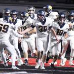 Members of the Forks football team gather around Hayden Queen (38) following his defensive touchdown early in the first quarter on Saturday against Tenino. It was his first of three touchdowns during the Evergreen 1A League game. Forks had plenty to celebrate during their 45-13 win on Saturday in Tenino.