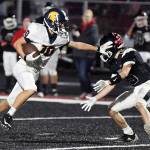 Logan Olson of Forks stiff arms a Tenino player en route to a first quarter touchdown during the Spartans 45-13 win on Saturday in Tenino. Photo by Mike Salsbury for The Forks Forum