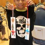 This young man from Bothell was in town with his mom who was Twilighting. He took advantage of the kids art activity at the Rainforest Art Center Saturday afternoon creating these two bookmarks! Photo Christi Baron