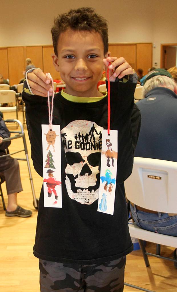 This young man from Bothell was in town with his mom who was Twilighting. He took advantage of the kids art activity at the Rainforest Art Center Saturday afternoon creating these two bookmarks! Photo Christi Baron