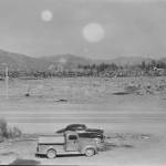 Tillicum Park -then- stumps were cleared and a photo taken of the future site of the towns park. The sign telling the story of the Forks fire can be seen in this photo taken across Highway 101. The train would be added later to the right of the sign. Boyd Rupp Photo