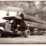 Three Wheel Truck Hauling Logs.
