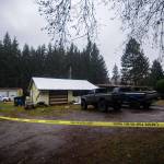 Crime scene tape surrounds a house on the 1300 block of Big Burn Place in Forks where investigators said a 17-year-old boy shot and killed a 19-year-old man after an early-morning party Sunday. (Jesse Major/Peninsula Daily News)