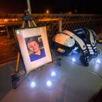 A photo of Tristen Pisani and shoulder pads sit on a table at Spartan Stadium during a candlelight vigil in Forks on Thursday. (Jesse Major/Peninsula Daily News)