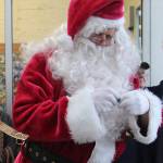 One of Santas many stops Saturday was the WEBPA Santa bucks Drawing outside Forks Outfitters. Here he reads one of the names of a lucky winner. Photo Christi Baron