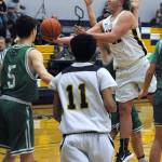 In JV action Spartan Derrick Beebe drives the lane for a shot while Forks Jonathan Jackson-Cruz looks on.
