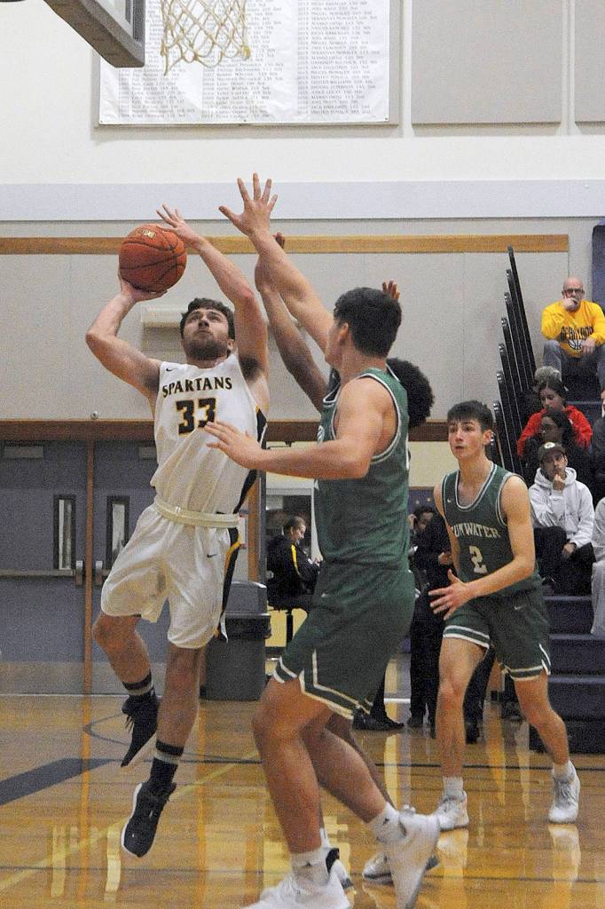 In varsity action Forks Skyler Steffen (33) scores on this drive to the basket.