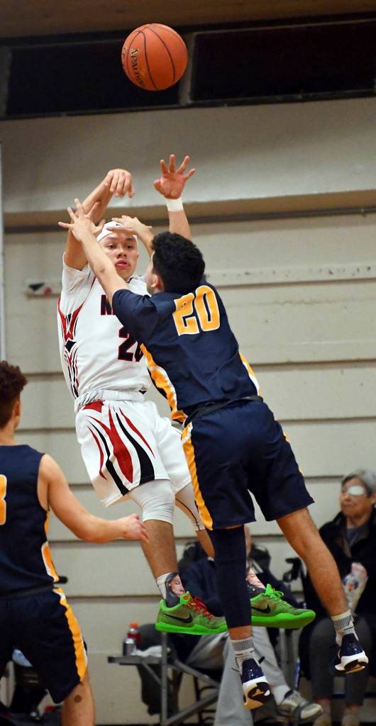 Tony Flores of Forks, right, maintains defensive pressure on Tobias Croy of Neah Bay on Thursday during the Spartans 49-36 win at Neah Bay.