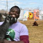 This April 10, 2020, photo shows Marshall Mitchell, Urban Farm Assistant at the Urban Growers Collective farm in Chicago. The nonprofit teaches young kids and others to grow vegetables at eight urban farms around the city. While their spring educational programs are on hold due to rules on social distancing, Laurell Sims, the co-founder, said they are still focusing on food production and getting produce to families that need it. (Laurell Sims via AP)