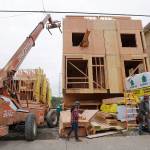 Because of the need to maintain a structural schedule, work continues on townhouses under construction during the coronavirus outbreak Friday, April 24, 2020, in Seattle. (Elaine Thompson/Associated Press)