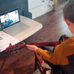 First-grader Leland Munn learns to play the guitar in a Zoom lesson from his teacher Emma Eliason. Eliason teaches Music in the Quilcene School District across all grades.