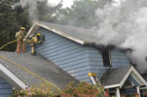 Firemen from District 1 fight a fire at the Peach home near MP 203 in Sappho at 5:30 p.m. Thursday, June 11. Law enforcement and Forks medics were also called to the scene. Photo by Lonnie Archibald