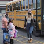 Students unload the bus heading toward the high school, Jr. high, and intermediate school, classes.