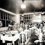 Hotel staff and others gather in the 1930s, inside the Woodland Hotel Cafe.