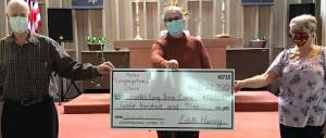 The Congregational Church recently took up an offering to help provide funds for stocking stuffers for residents at FCH Long Term Care. They raised $1,200! Seen here with the Big Check are Vern Farrell, Dawn Harris, and Edith Henry.