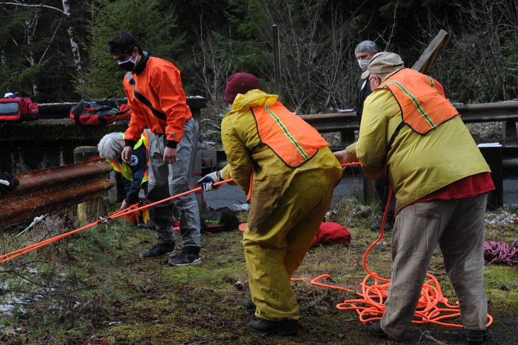 Ropes and pulleys are used to help rescuers bring the victim to the highway from the bank of the river. He was then loaded into the Forks ambulance and taken to FCH, and later airlifted to Harborview.