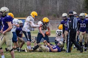 Spartan Sportsmanship - Senior Hayden Baker (#30) showing Spartan sportsmanship, as he extends a hand to help up an opponent during Saturdays game at Onalaska. Photo by Kim Weissenfels, more photos page 9.