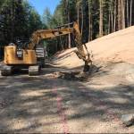 Finishing the slope and establishing the ditch-line for the new alignment of the road approaching the Canyon Creek bridge. Photos FHWA