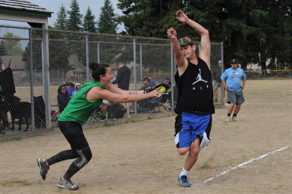 Mossquatch catcher Amanda Cheney attempts to tag a Good Wood runner out at home. A close call as the runner was safe. Mossquatch won this thriller 13-12.
