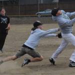 Team Gramps shortstop Dalton Kilmer reaches in an attempt to tag Forks Merchant runner Tyler Penn out in Sundays game won by Team Gramps 16-10.