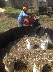 Al Cairo preparing shredded garden waste and filling the Johnson-Su composting bioreactor at Woodcock Garden. Photo credit: Al Cairo