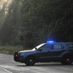Law enforcement blocks the Sitkum Sol Duc Road early Saturday morning while medics, firemen, and law enforcement were active at the scene of the accident near milepost 5.  Photo by Lonnie Archibald