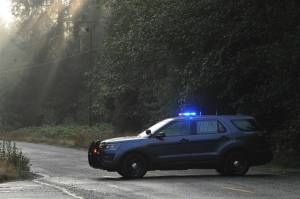 Law enforcement blocks the Sitkum Sol Duc Road early Saturday morning while medics, firemen, and law enforcement were active at the scene of the accident near milepost 5.  Photo by Lonnie Archibald